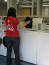 student putting clothes in the washer