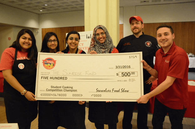 The Spicy Seawolves along with their Campus Dining chef, Ryan Carroll and Seawolves Food Show reporter Taylor Alessi showing off their grand prize of $500 that was donated to The Sunrise Fund.