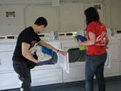 students transferring clothes to the dryer