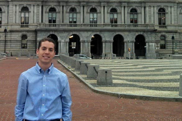 Christopher Lang stands in front of the New York Capitol Building in Albany